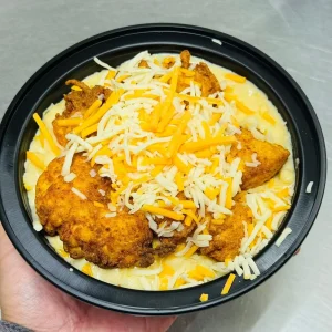 A creamy bowl of macaroni and cheese topped with crispy fried chicken pieces at Mo’s in Simsbury.